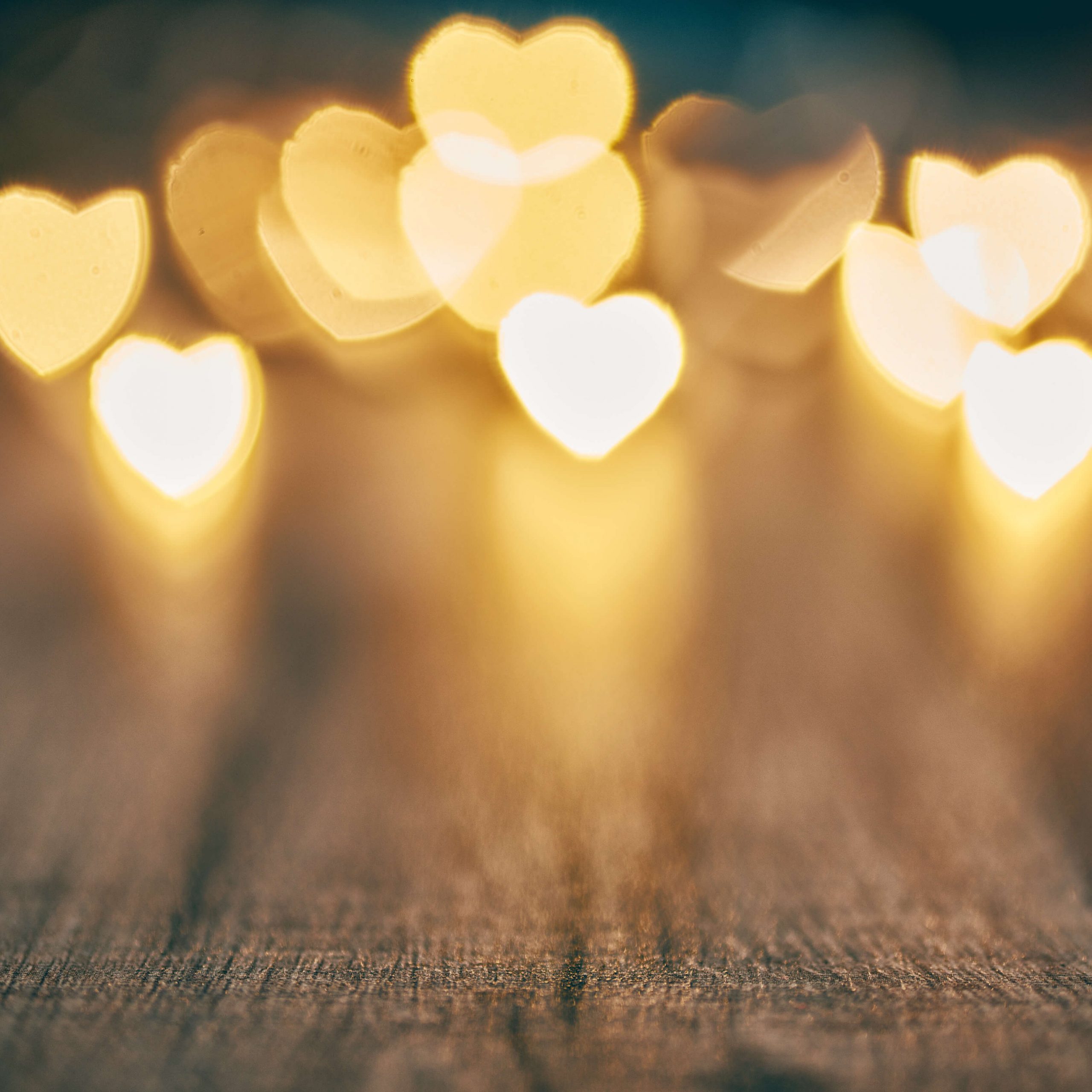 bokeh hearts shining over a wood table