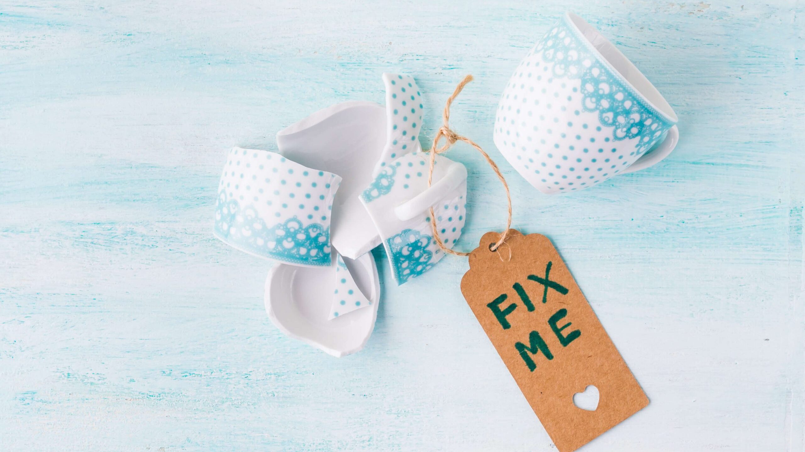 broken cup tagged "Fix me"