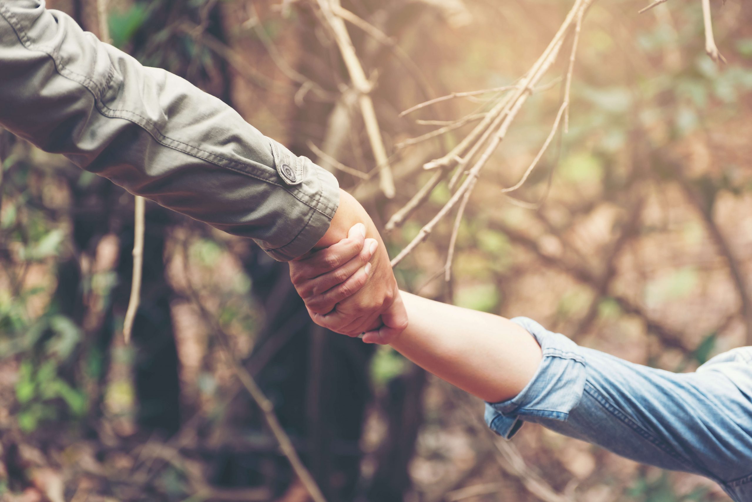 man gives helping hand to woman