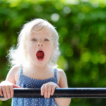 girl shouts over fence