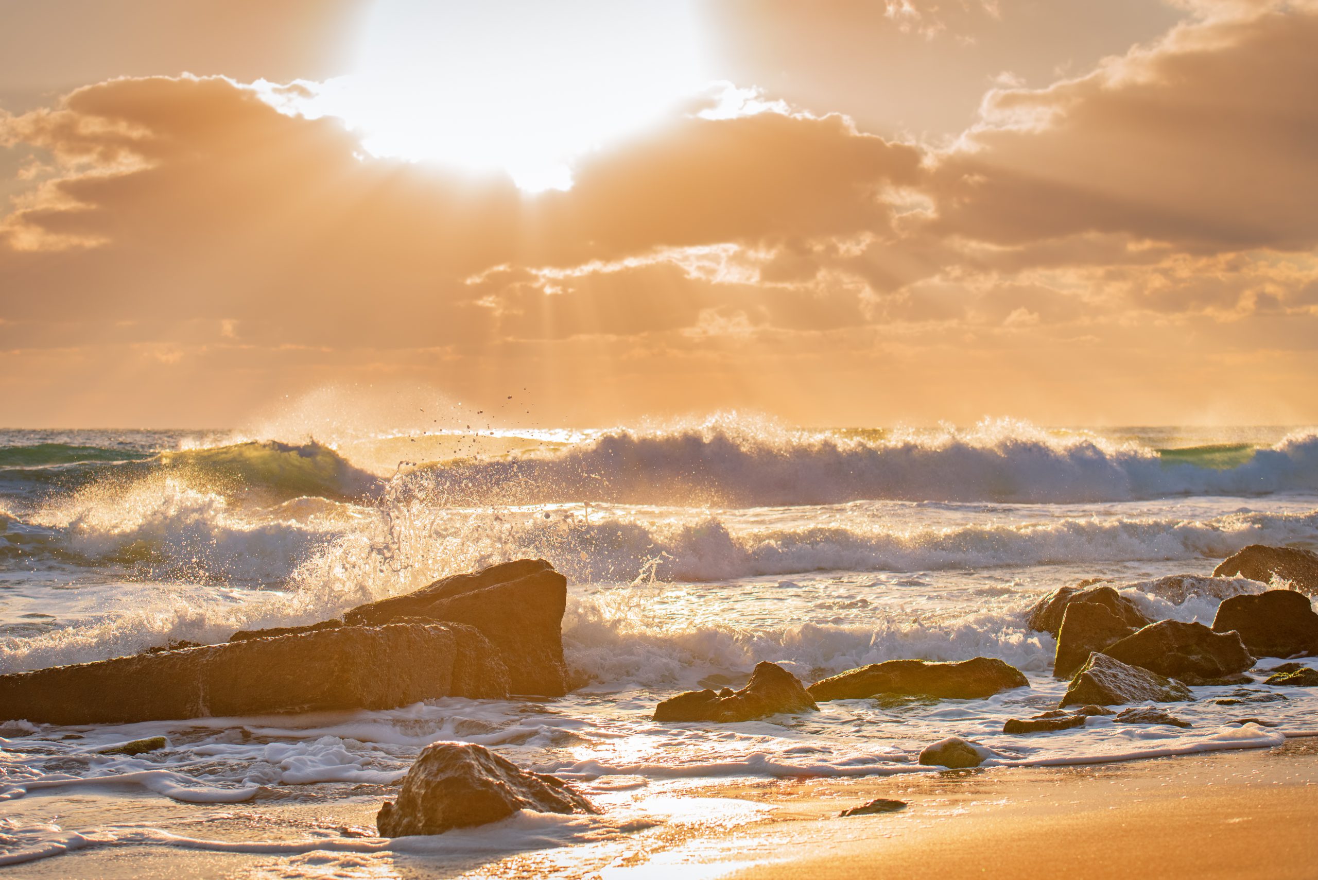 waves crash against rocks on shore