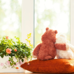orange teddy on pillow