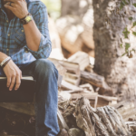 man-reading-bible-woods.webp